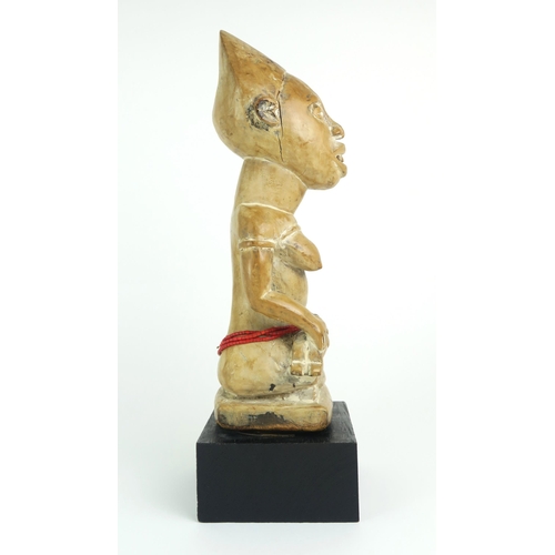 2399 - A MAYOMBE MOTHER AND BABY FIGURE, WEST CENTRAL AFRICACarved from a pale softwood, sat upon a later p... 