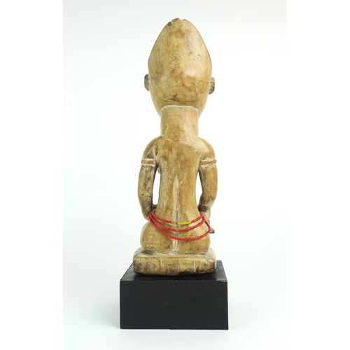 2399 - A MAYOMBE MOTHER AND BABY FIGURE, WEST CENTRAL AFRICACarved from a pale softwood, sat upon a later p... 