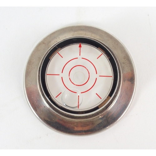 2466 - TIFFANY; A silver mounted spirit level, of circular form, stamped 'Tiffany & Co Sterling' to bas... 