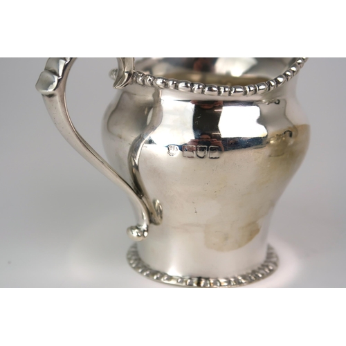 2469 - AN EDWARDIAN BACHELORS SILVER TEA SERVICEmaker's mark rubbed, London 1911, of baluster form, with a ... 