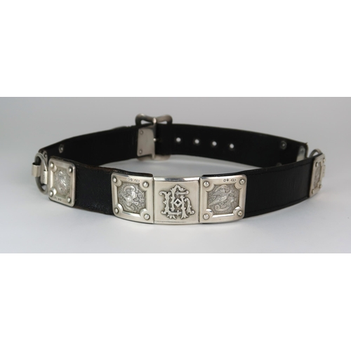 2476 - A VICTORIAN SILVER MOUNTED BLACK LEATHER BELTby Thomas Johnson I, London 1874, the panels decorated ... 