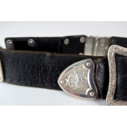 2476 - A VICTORIAN SILVER MOUNTED BLACK LEATHER BELTby Thomas Johnson I, London 1874, the panels decorated ... 