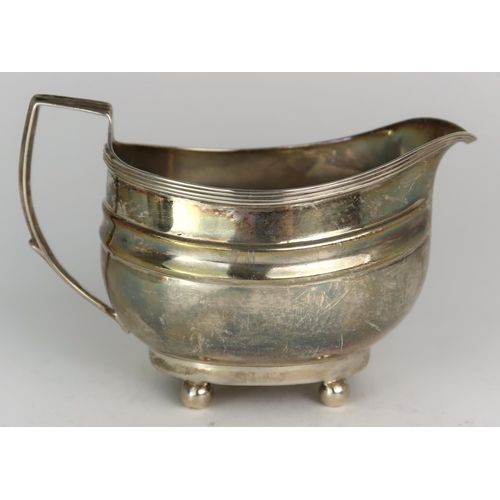 2482 - A GEORGE III SILVER CREAM JUGmaker's mark rubbed, London 1806, of oval form, with two shaped bands, ... 