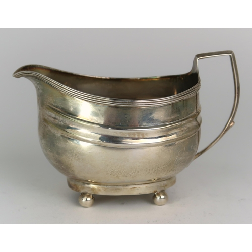 2482 - A GEORGE III SILVER CREAM JUGmaker's mark rubbed, London 1806, of oval form, with two shaped bands, ... 