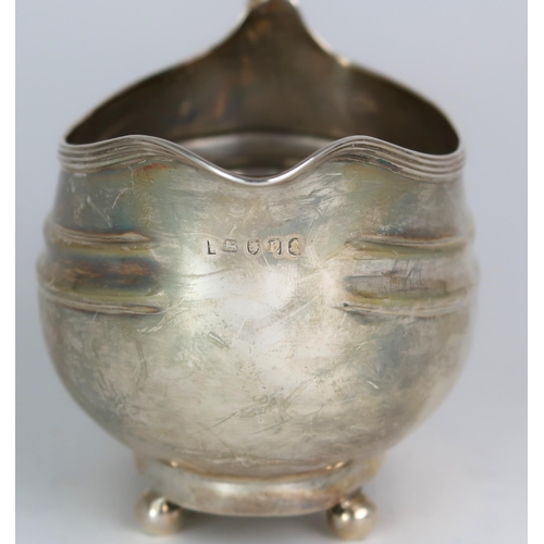 2482 - A GEORGE III SILVER CREAM JUGmaker's mark rubbed, London 1806, of oval form, with two shaped bands, ... 