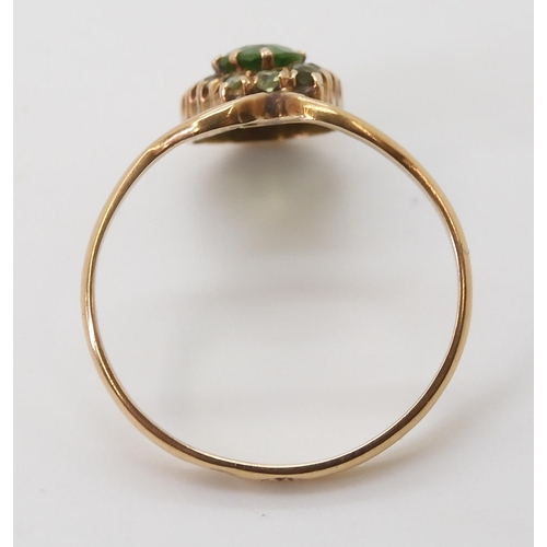 2702 - A RUSSIAN GOLD DEMANTOID GARNET RINGin an early 20th Century style, the central demantoid garnet has... 