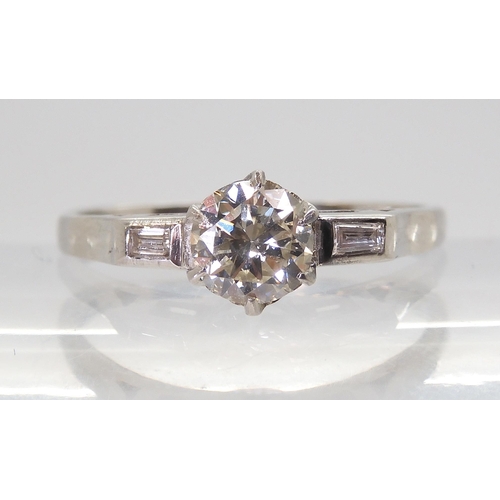 2703 - A CLASSIC VINTAGE DIAMOND RINGset with an estimated approx 0.58ct brilliant cut diamond, with furthe... 