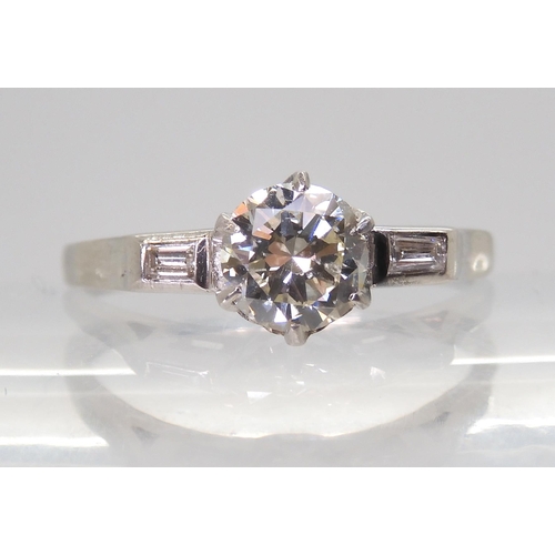 2703 - A CLASSIC VINTAGE DIAMOND RINGset with an estimated approx 0.58ct brilliant cut diamond, with furthe... 