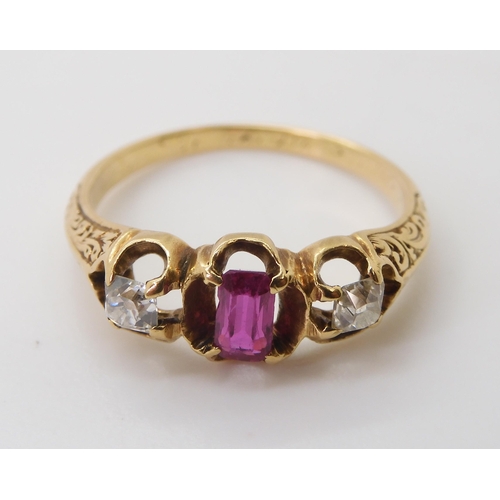 2705 - A VINTAGE THREE STONE RINGset with two old cut diamonds and a mixed cut ruby in a scroll engraved se... 