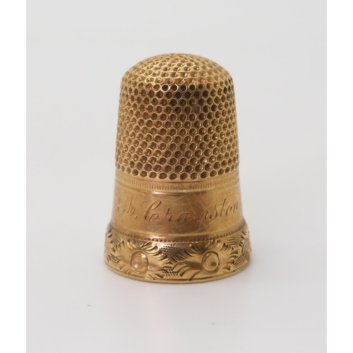 2708 - A YELLOW METAL THIMBLEfrom the Cranston family estate, engraved 'M. Cranston' with a flower engraved... 