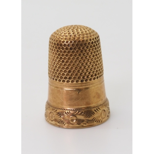 2708 - A YELLOW METAL THIMBLEfrom the Cranston family estate, engraved 'M. Cranston' with a flower engraved... 