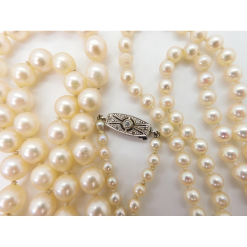 2716 - TWO STRINGS OF PEARLS WITH DECORATIVE CLASPSthe smaller strand, the pearls taper in size from 7mm to... 