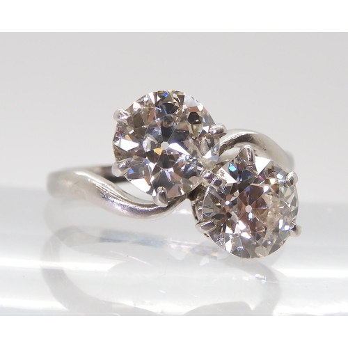 2720 - A SUBSTANTIAL TWIN STONE DIAMOND RINGset with two old cut diamonds with an estimated approx diamond ... 