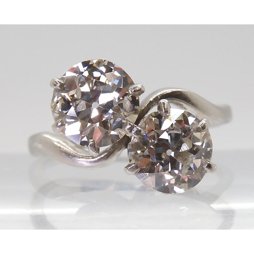 2720 - A SUBSTANTIAL TWIN STONE DIAMOND RINGset with two old cut diamonds with an estimated approx diamond ... 