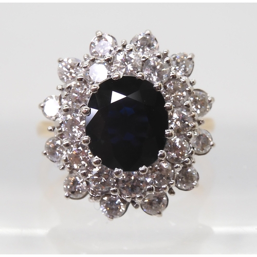 2721 - A SAPPHIRE AND DIAMOND CLUSTER RINGthe 16.8mm x 18mm cluster, mounted throughout in yellow and white... 