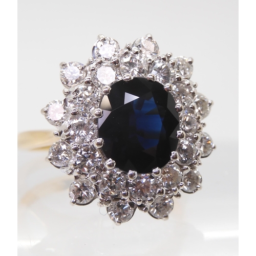 2721 - A SAPPHIRE AND DIAMOND CLUSTER RINGthe 16.8mm x 18mm cluster, mounted throughout in yellow and white... 