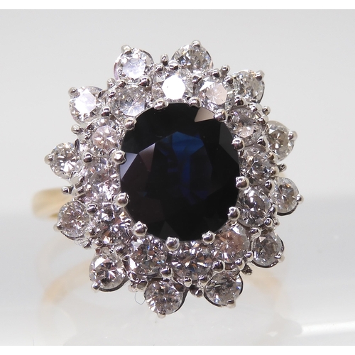 2721 - A SAPPHIRE AND DIAMOND CLUSTER RINGthe 16.8mm x 18mm cluster, mounted throughout in yellow and white... 