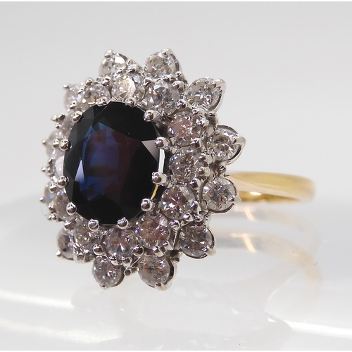 2721 - A SAPPHIRE AND DIAMOND CLUSTER RINGthe 16.8mm x 18mm cluster, mounted throughout in yellow and white... 