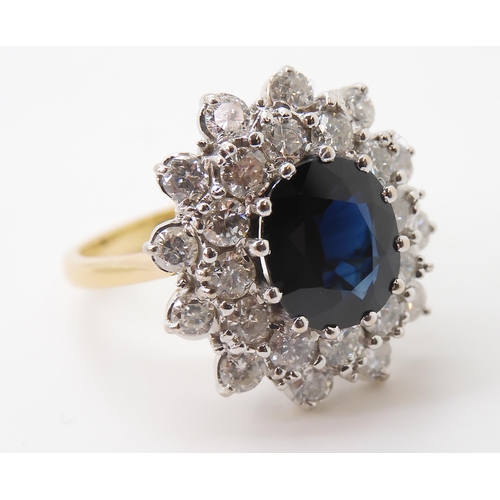 2721 - A SAPPHIRE AND DIAMOND CLUSTER RINGthe 16.8mm x 18mm cluster, mounted throughout in yellow and white... 