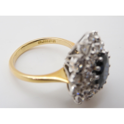 2721 - A SAPPHIRE AND DIAMOND CLUSTER RINGthe 16.8mm x 18mm cluster, mounted throughout in yellow and white... 