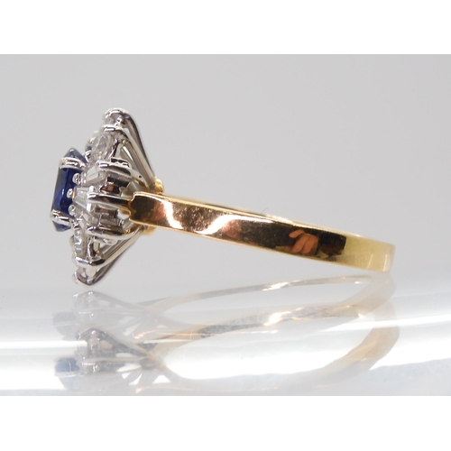 2724 - A SAPPHIRE & DIAMOND CLUSTER RINGset in 18ct yellow and white gold, the starburst configuration ... 