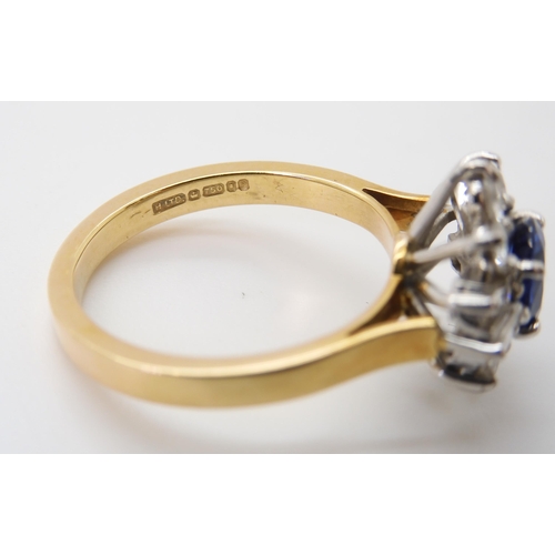 2724 - A SAPPHIRE & DIAMOND CLUSTER RINGset in 18ct yellow and white gold, the starburst configuration ... 