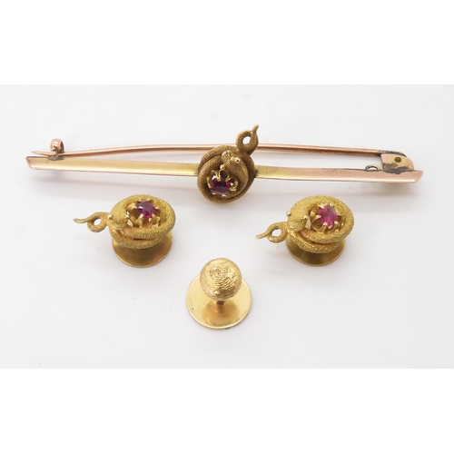 2732 - A VICTORIAN RUBY SNAKE SETof long brooch and two matching shirt studs, with a detailed snake encircl... 