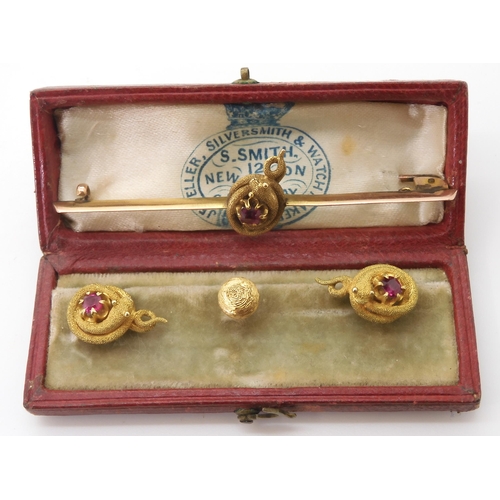 2732 - A VICTORIAN RUBY SNAKE SETof long brooch and two matching shirt studs, with a detailed snake encircl... 