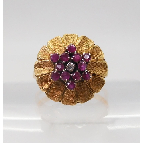 2740 - AN ITALIAN RETRO FLOWER CLUSTER RINGset with rubies and a diamond, mounted throughout in 18ct yellow... 