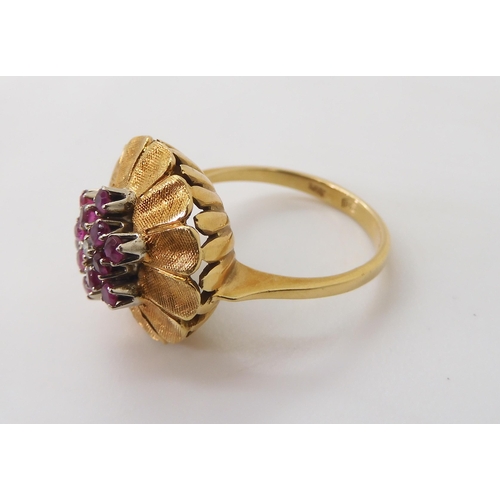 2740 - AN ITALIAN RETRO FLOWER CLUSTER RINGset with rubies and a diamond, mounted throughout in 18ct yellow... 