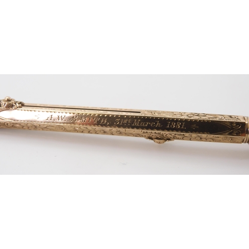 2744 - A PROPELLING PEN & PENCILthe yellow metal body with all over floral and scrolled engraving, with... 