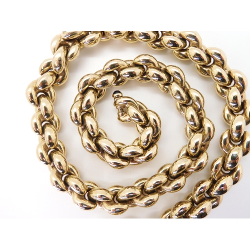 2751 - A 9CT GOLD CHIAMPESAN FANCY CHAINwith hollow puffed links, and a sapphire cabochon set to the clasp ... 