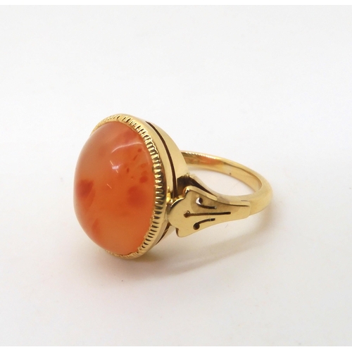 2824 - AN CARNELIAN RINGthe 18ct gold mount has pierced shoulders and a engraved setting. Finger size L, we... 