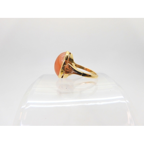 2824 - AN CARNELIAN RINGthe 18ct gold mount has pierced shoulders and a engraved setting. Finger size L, we... 