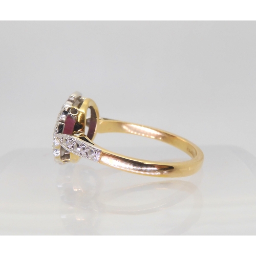 2825 - A VINTAGE RUBY AND DIAMOND RINGset with a central ruby surrounded with eight cut diamonds, to a flow... 