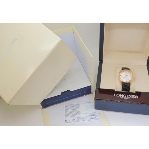 2874 - A LONGINES AUTOMATIC CONQUESTthe 18ct gold model, with silvered dial, gold coloured dagger numerals ... 