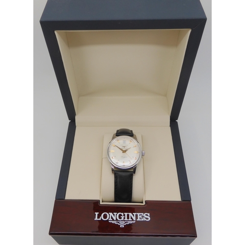 2879 - A LONGINES AUTOMATIC CONQUESTwith a silvered dial gold coloured dagger numerals and hands, with date... 