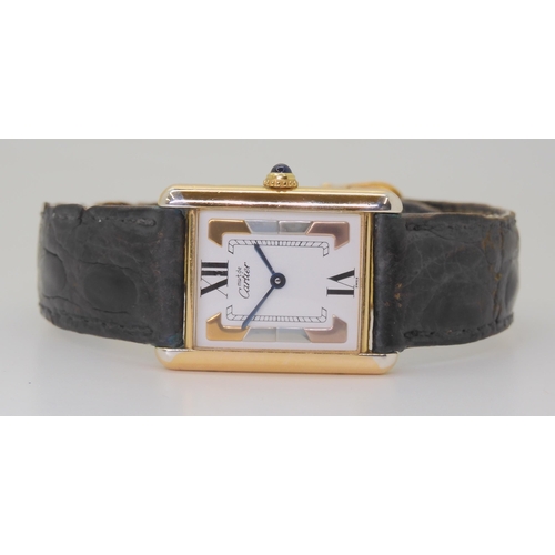 2880 - A LADIES MUST DE CARTIER TANK WATCHthis model has a three coloured gold detailed dial with 12 & ... 