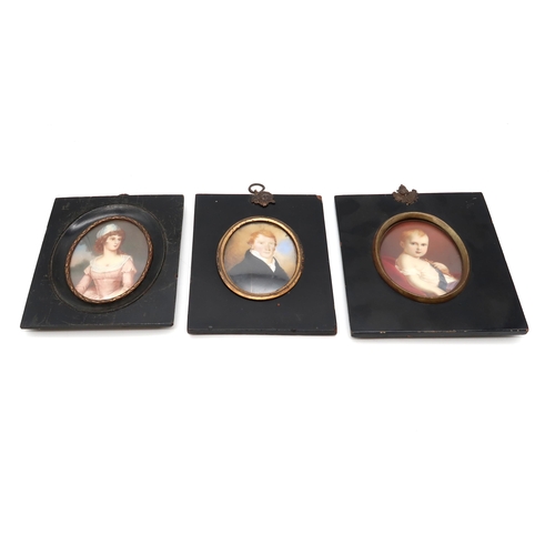 2569 - THREE EARLY-19th CENTURY PORTRAIT MINIATURESPainted on ivory, depicting respectively a red-haired ge... 