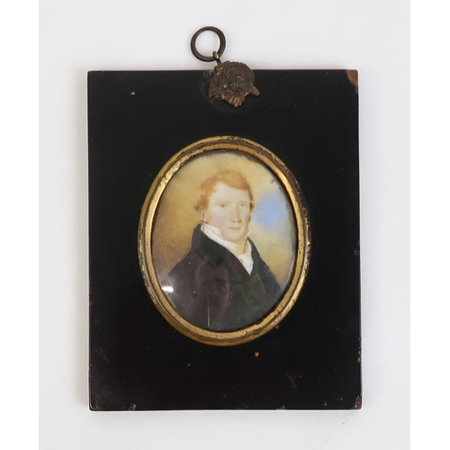 2569 - THREE EARLY-19th CENTURY PORTRAIT MINIATURESPainted on ivory, depicting respectively a red-haired ge... 