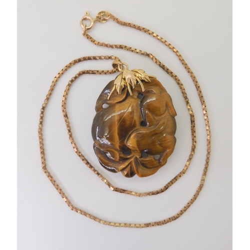 2790 - A CHINESE PENDANT CARVED WITH A RABBITcarved in tiger's eye the rabbit is depicted with pumpkins, mo... 