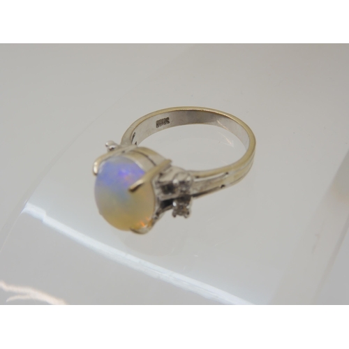 2797 - AN OPAL AND DIAMOND RINGmounted throughout in 18ct white gold, the oval opal is approx 11.3mm x 9.4m... 