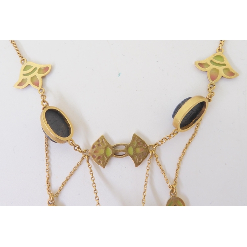 2802 - AN EGYPTIAN REVIVAL NECKLACEmade in gilded white metal, with plique a jour enamel ankhs and lotus fl... 