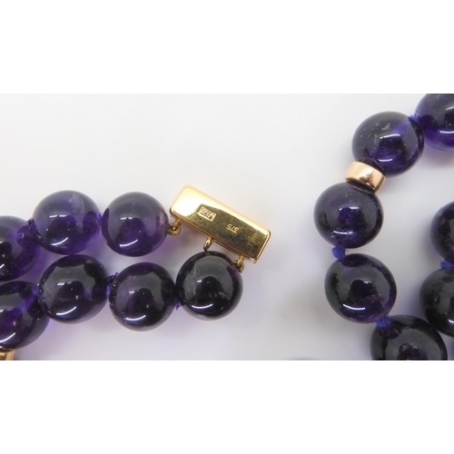 2764 - A STRING OF LARGE AMETHYST BEADSeach bead is approx 11mm, interspaced at intervals with 9ct barrel b... 