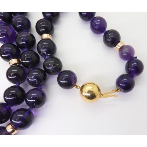 2764 - A STRING OF LARGE AMETHYST BEADSeach bead is approx 11mm, interspaced at intervals with 9ct barrel b... 