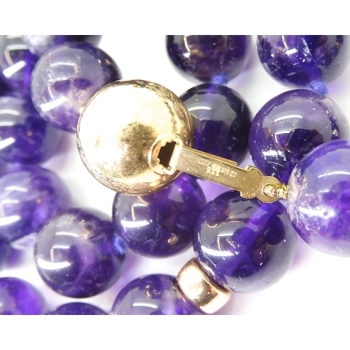 2764 - A STRING OF LARGE AMETHYST BEADSeach bead is approx 11mm, interspaced at intervals with 9ct barrel b... 