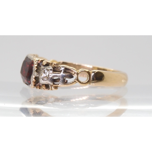 2766 - A GEORGIAN STYLE RINGmounted in yellow metal set with a red gem and rose cut diamonds, finger size a... 