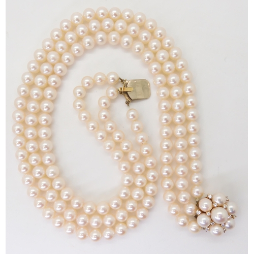 2767 - AN 18CT GOLD PEARL AND DIAMOND PEARL CLASPfor a three-string pearl collar. Each pearl of approx 6.9m... 