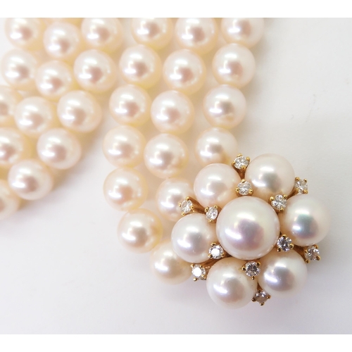 2767 - AN 18CT GOLD PEARL AND DIAMOND PEARL CLASPfor a three-string pearl collar. Each pearl of approx 6.9m... 