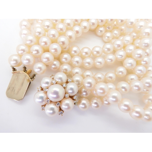 2767 - AN 18CT GOLD PEARL AND DIAMOND PEARL CLASPfor a three-string pearl collar. Each pearl of approx 6.9m... 